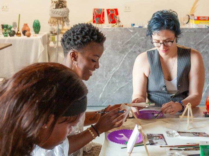 Women painting together at a workshop table